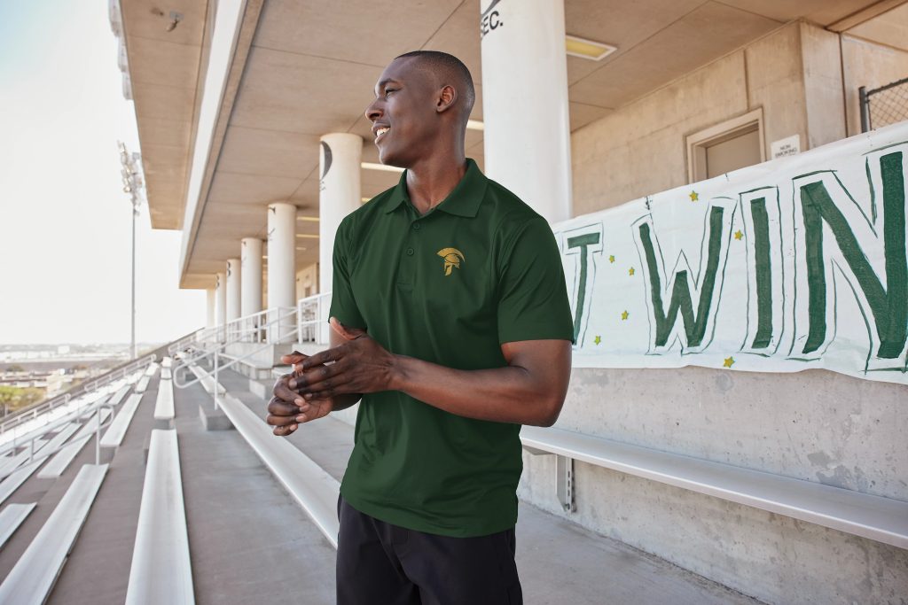 Golfer wearing Sport-Tek ST650 Micropique Sport-Wick Polo, delivering a polished look with moisture-wicking performance