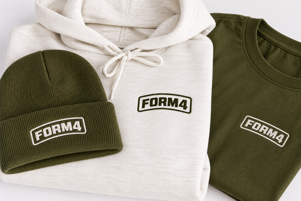 Custom branded apparel featuring embroidered logos on a beanie, hoodie, and T-shirt in olive green and cream.